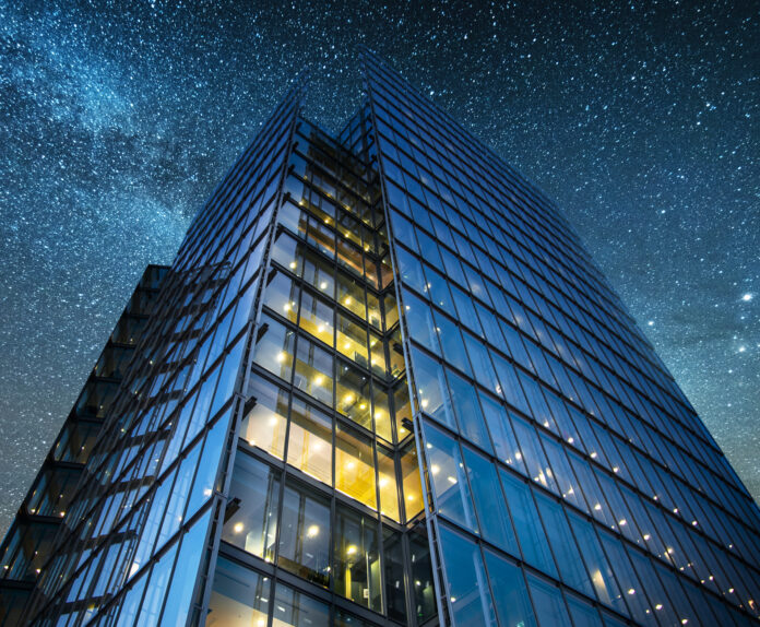 office building at night skyscraper into starry sky. Tech- and artificial-intelligence-focused companies