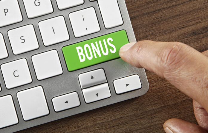 Green bonus key on a laptop to signify the need to revamp total-rewards programs