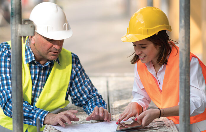 A man and woman in construction gear, represents the skilled-trade worker shortages and the need to renovate the skilled-trade workforce