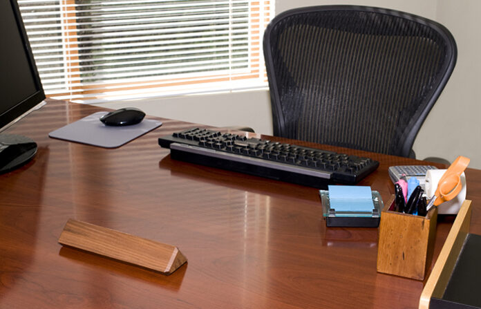 Empty desk and blank name plate for HR job titles and VP of people and culture