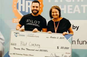 Pitchfest winner Pilot Coaching CEO Ben Brooks accepts the winner's check for $25,000.