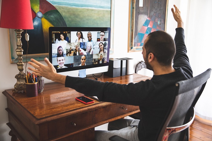 Man in Video call with friends and relatives in front of computer