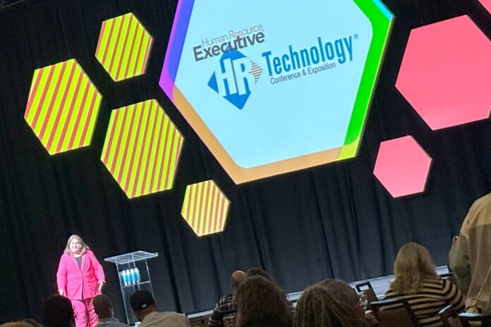 Stacey Harris on stage at HR Tech; 2024 HR data reveals most pressing business outcomes